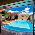 Summer home with Bright pool area with blue sky