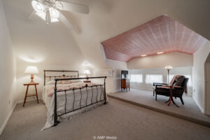 Cozy attic bedroom with seating area to sell your home fast
