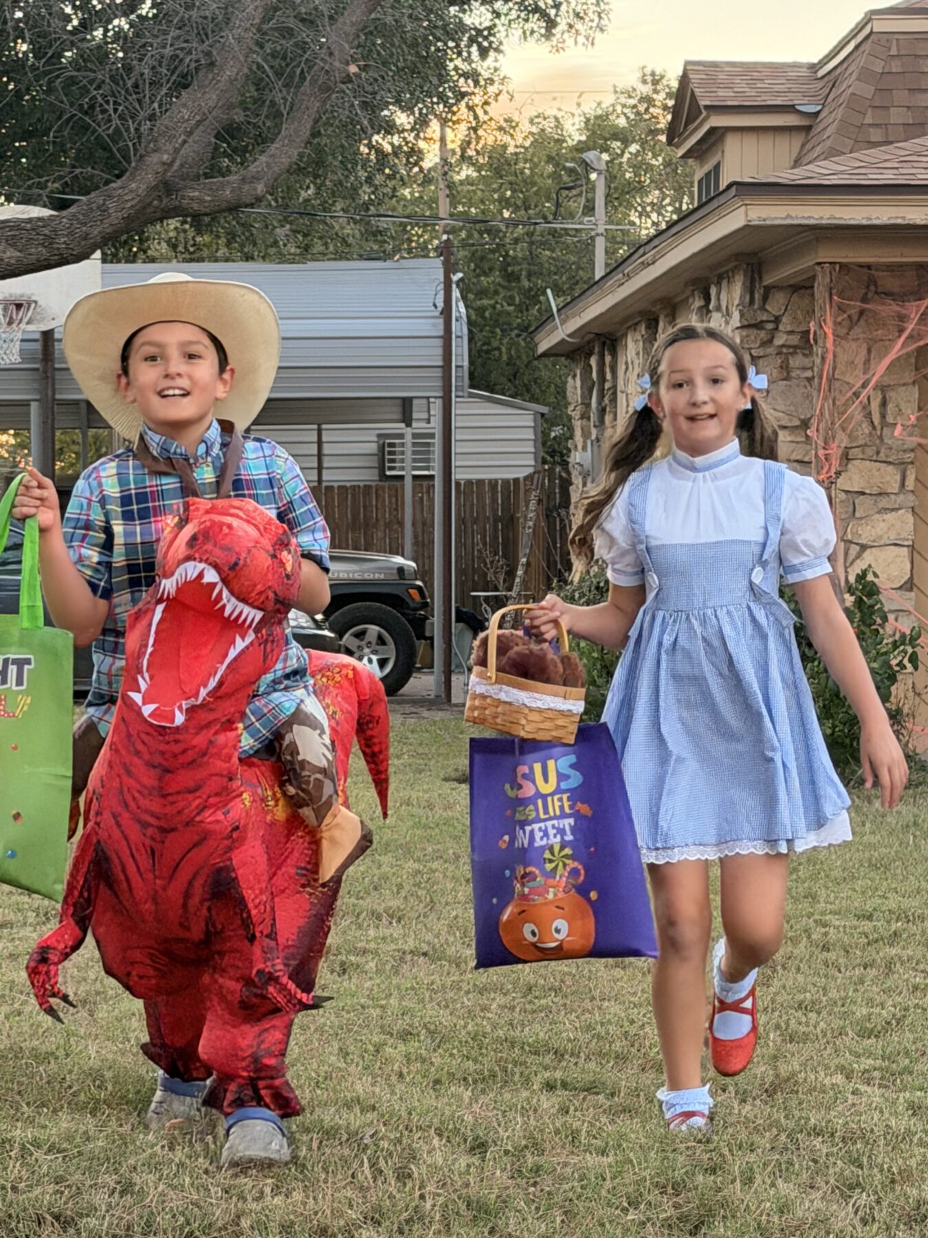 Children in Halloween costumes carrying candy bags in Stamford, Texas