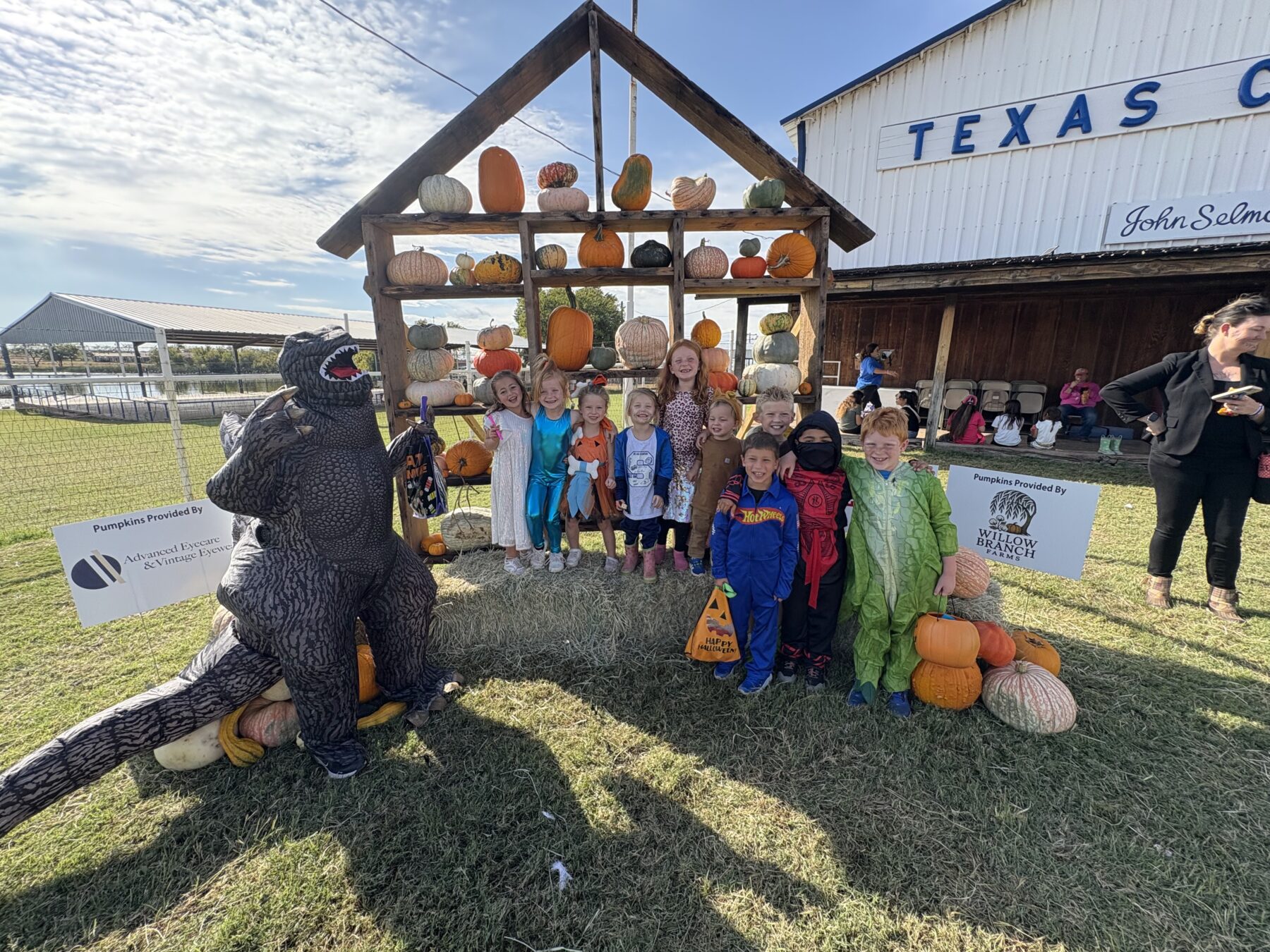 Kids in costumes posing with pumpkins at the Stamford Fall Festival