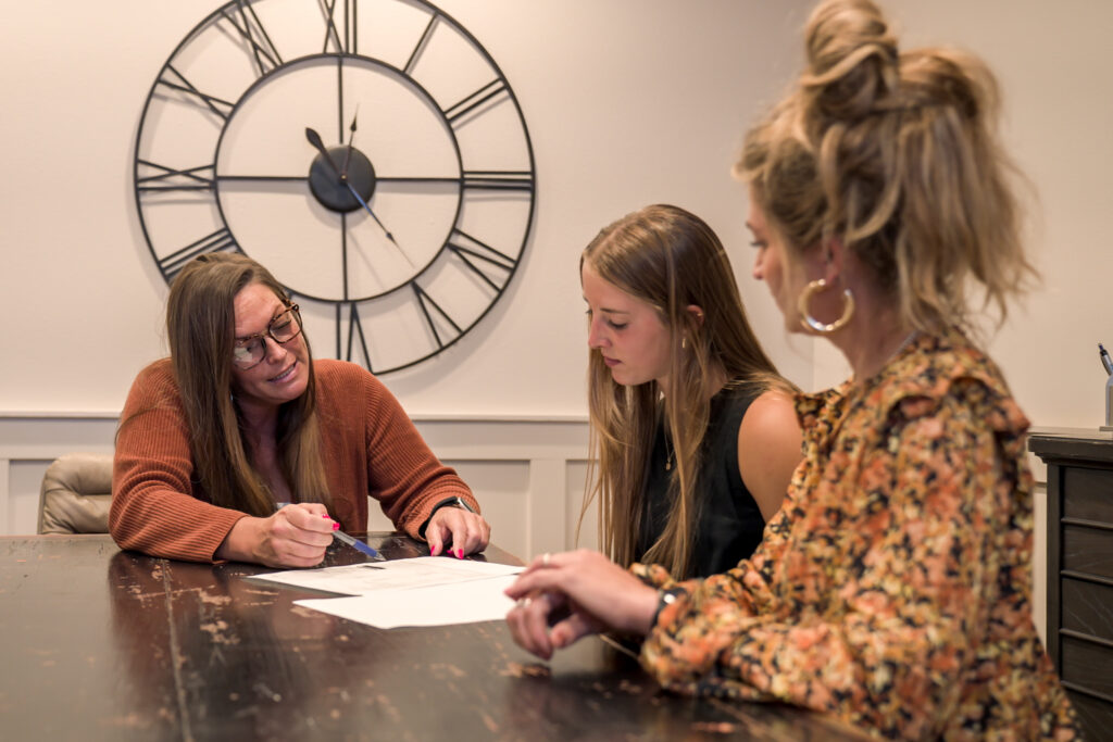 Women understanding real estate contracts at a table